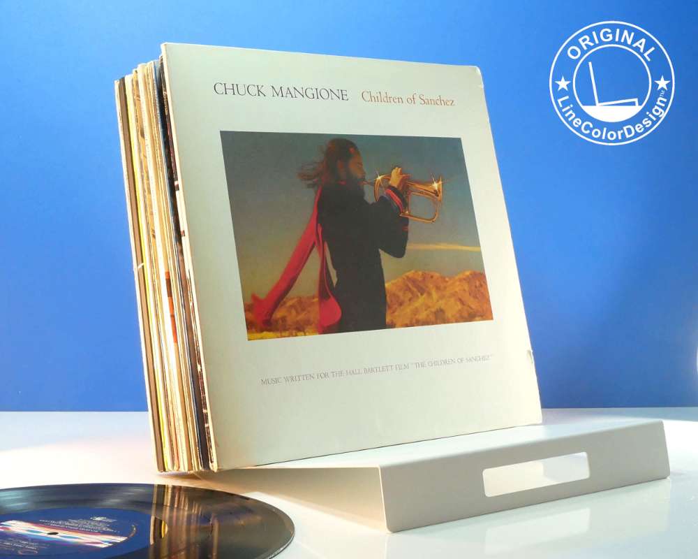 minimalist white metal sloping rack holding a chuck mangione vinyl album  beautiful