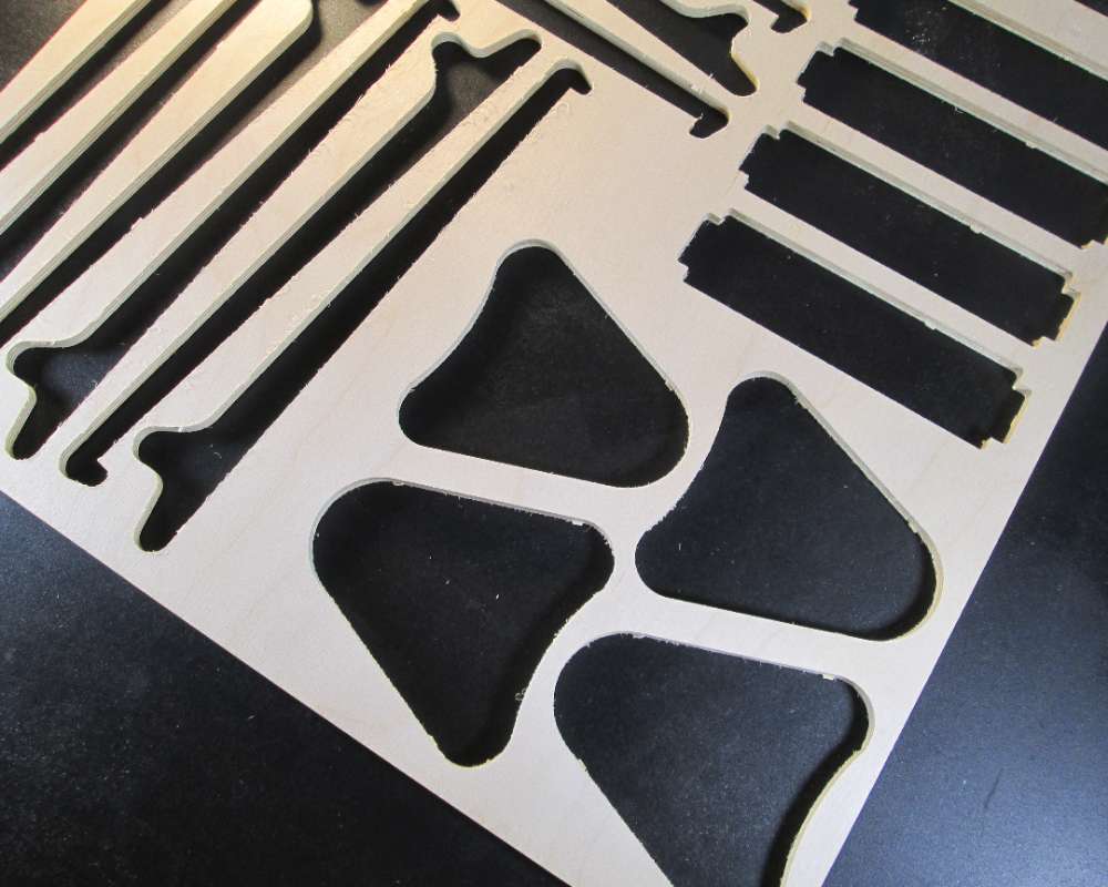 baltic birch plywood with holes cut out from pieces used to make handmade products